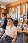 Portrait smiling, confident creative businesswoman drinking tea in office