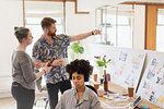 Creative designers examining bottles in office