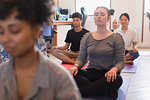 Serene creative businesswoman meditating in office