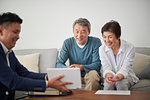 Japanese senior couple talking with consultant