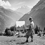 1920s 1930s ARTIST WORKING ON PAINTING STANDING AT EASEL IN BERNESE OBERLAND SWITZERLAND