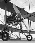 CIRCA 1911 CURTISS PUSHER MODEL D ENGINE AND PROPELLER ARE MOUNTED BEHIND THE PILOT RESTING ON A TRICYCLE WHEEL UNDERCARRIAGE