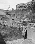 1930s WOMAN TOURIST STANDING IN CHETRO KETL RUINS CHACO CANYON NEW MEXICO USA