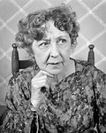 1930s 1940s UNCERTAIN SENIOR WOMAN WITH WORRIED EXPRESSION LOOKING TO SIDE BY TELEPHONE