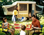 1970s FAMILY OF FIVE EATING MEAL BY POP-UP CAMPER TRAILER RECREATIONAL VEHICLE