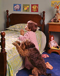 1970s 1980s LITTLE RED HAIR GIRL KNEELING IN BEDROOM BESIDE BED SAYING PRAYERS WITH PET WIRE HAIR TERRIER DOG ALONGSIDE