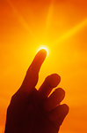 2000s ANONYMOUS SILHOUETTED HAND FINGER POINTING UP REACHING TO TOUCH SUN LIGHT RELIGIOUS SYMBOLIC