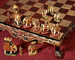 1950s CHESS SET IN STYLE OF INDIA ELEPHANTS AND MAHARAJA HUNTING PARTY ON RAISED ORNATE CHESSBOARD