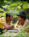 1970s ROMANTIC AFRICAN AMERICAN COUPLE SMILING SPEAKING TALKING FACE TO FACE EYE TO EYE OUTDOORS