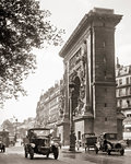 1920s AUTOMOBILES PASSING PORTE SAINT DENIS ARCH AT SAINT DENIS BOULEVARD FIRST OF FOUR TRIUMPHAL  MONUMENTS IN PARIS FRANCE