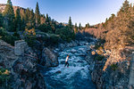 Man highlining above river, Truckee, California, USA