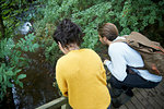 Hiker couple looking over wooden bridge