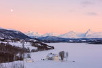 Sunrise on typical house with Lyngen Alps in the background, Mestervik, Troms county, Norway, Scandinavia, Europe