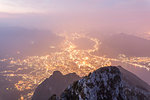 Illuminated city of Lecco seen from Monte Coltignone at dawn, Lombardy, Italy, Europe
