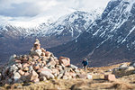 A cairn and a walker at the top of the Devils Staircase while hiking along the West Highland Way near Glencoe in the Scottish Highlands, Scotland, United Kingdom, Europe