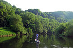 Paddle boarder deep in the Wye Valley Gorge, River Wye, Monmouthshire, Wales, United Kingdom, Europe