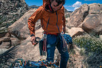 Rock climber wearing safety gear, Joshua Tree, California, USA