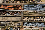 Close up of large bug house with several layers of different materials.