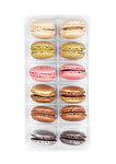 French colorful macarons dessert cakes in plastic tray on white background