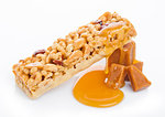 Caramel protein cereal energy bar with liquid toffee on white background