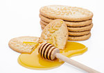 Healthy bio breakfast grain biscuits with honey on white background