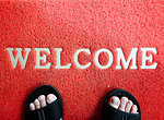 Closeup red mat with welcome and foot