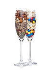 Popcorn and candies glass with healthy nuts glass on white background