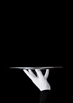 Servant wearing white glove holds stainless steel tray on black background