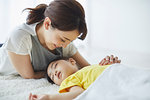 Japanese mother with sleeping kid