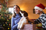 Portrait happy brother and sister with dog in Christmas gift box