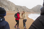 Family walking on snowy winter beach