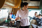 Mother cooking for family in motor home