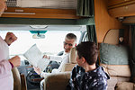 Father and son looking at map in motor home