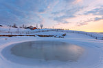 Winter dusk at Farmhouse Casera Mezzomiglio, Prealps of Belluno, Farra d'Alpago, Belluno province, Veneto, Italy