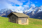 Traditional huts with Pizzo Badile and Masino-Bregaglia group in the background. Soglio, Val Bregaglia(Bregaglia Valley), Graubünden, Switzerland, Europe.