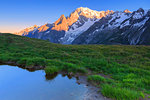 Water puddle with a view of Mont Blanc at dawn. Mont de la Saxe, Ferret Valley, Courmayeur, Aosta Valley, Italy, Europe