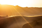 People walking on the edge of a sand dune at sunset,Walvis Bay,Namibia,Africa