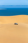 Offroad vehicle on top of the sand dunes,Sandwich Harbour, Namib Naukluft National Park,Namibia,Africa