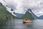 Touristic boat cruising in Milford Sound. Fiordland NP, Southland district, Southland region, South Island, New Zealand.