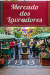 Customers under the sign at the entrance of Mercado dos Lavradores - Farmers' Market. Funchal, Madeira region, Portugal.