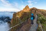 Woman admiring the view from PR1 trail. Pico do Arieiro, Funchal, Madeira region, Portugal.