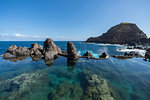 Natural pools with Mole islet in the background. Porto Moniz, Madeira region, Portugal.