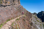 Hiker walking on the trail from Pico Ruivo to Pico do Areeiro. Funchal, Madeira region, Portugal.