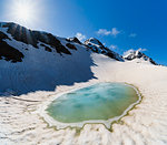A small thaw lake under Sforzellina Peak. Santa Caterina Valfurva, Gavia pass, Lombardy, Italy.