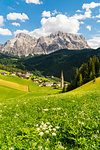 Summer landscape of La Val between greem meadows. Badia valley, Trentino Alto Adige, Italy