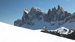 a hiker is walking with snowshoes in Val Gardena with the Geisler Group in the background, Bolzano province, South Tyrol, Trentino Alto Adige, Italy