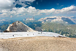 a beautiful landscape from the top of the Marmolada with a group of hikers walking on a glacier, Trento province, Trentino Alto Adige, Italy,