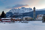 View of Presolana and the Vilminore church during a winter sunset. Vilminore, Val di Scalve, Bergamo district, Lombardy, Italy.