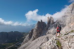 Cristallino di Misurina, Misurina, Dolomites, province of Belluno, Veneto, Italy. A climber admired the Campanile Dibona, also called lobster claw