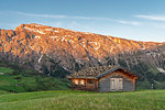 Alpe di Siusi/Seiser Alm, Dolomites, South Tyrol, Italy. Alpenglow in the rock walls of the Denti di Terrarossa